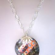 Necklace, Sparkling Swarovski Crystal Peacock Eye faceted Twist pendant on a silver chain.